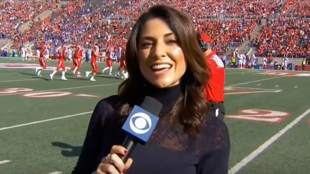 CBS' Jenny Dell works the sideline during a game.