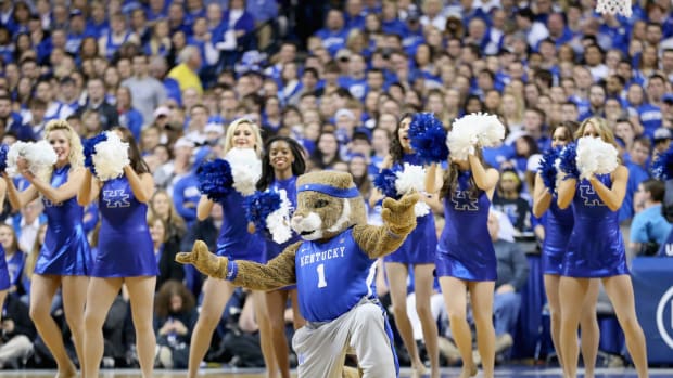 Kentucky's mascot wearing a blue Kentucky jersey while performing with the cheerleaders.