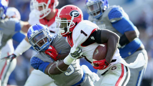 Sony Michel shedding a Kentucky player's tackle.