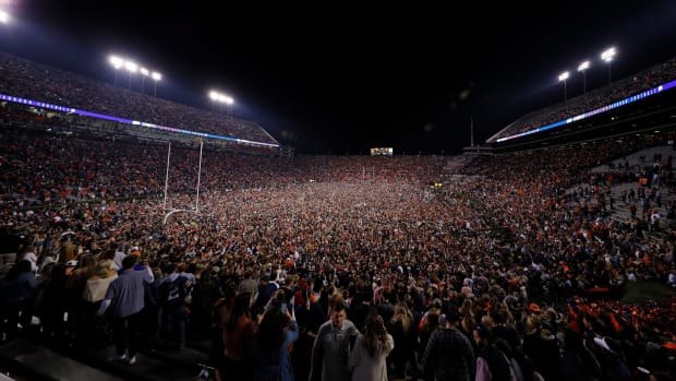 Auburn fans storm the field after beating Alabama.