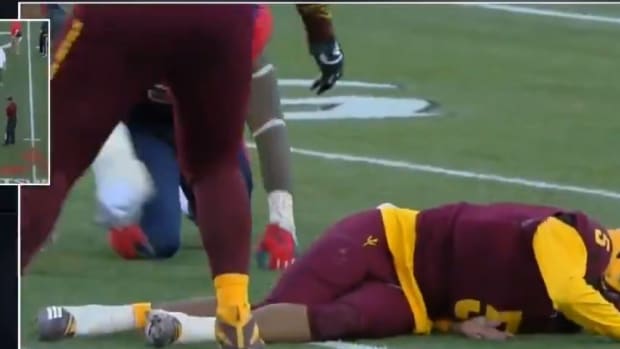 Arizona State quarterback Manny Wilkins down with an injury during bowl game against Fresno State.