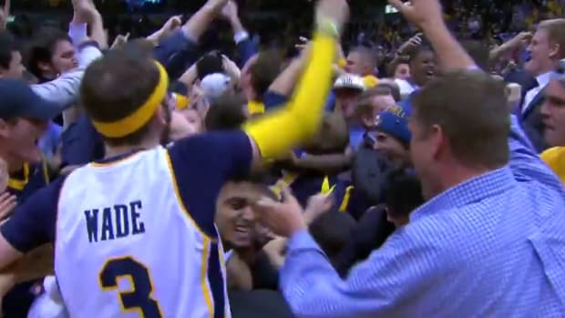 Marquette's fans storm the court after they beat Villanova.