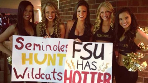 Florida State cheerleaders holding up signs.