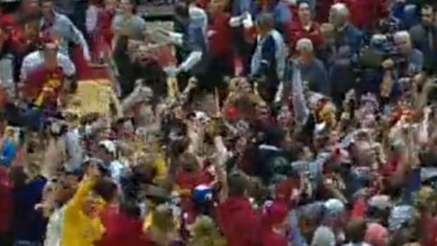 Iowa State fans storm the court after beating Oklahoma.