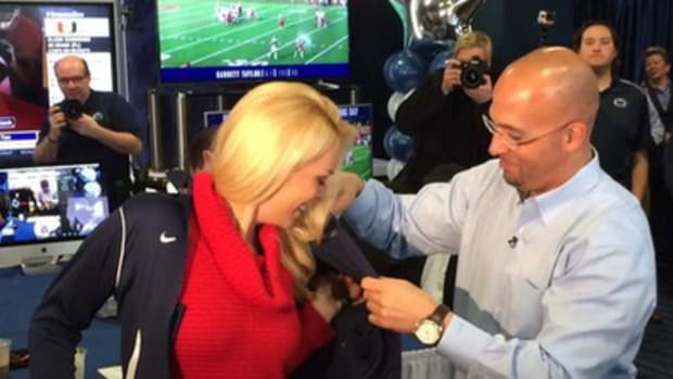 James Franklin gives Britt McHenry a blue jacket to wear.