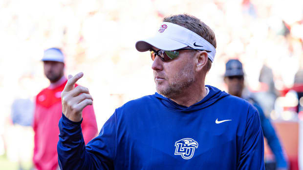 Hugh Freeze on the field for the Arkansas-Liberty game.
