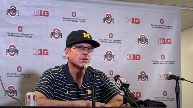 Jim Harbaugh speaks at a press conference.