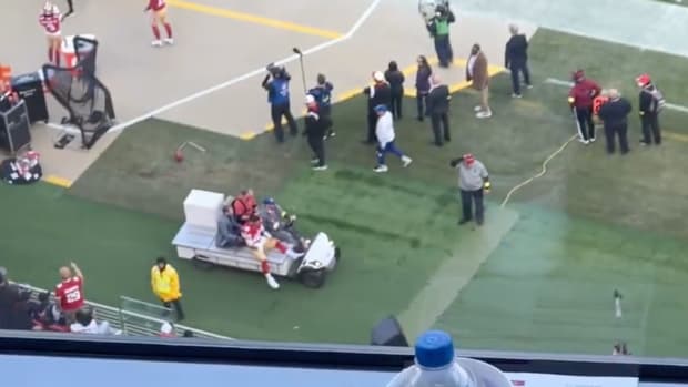 Jimmy Garoppolo on the field getting carted off.