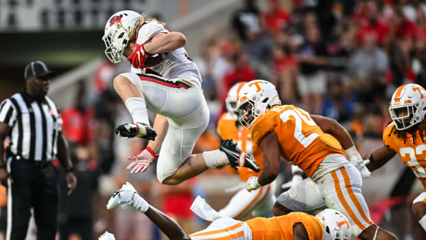 Ball State running back Carson Steele hurdles a defender while running with the ball against Tennessee.