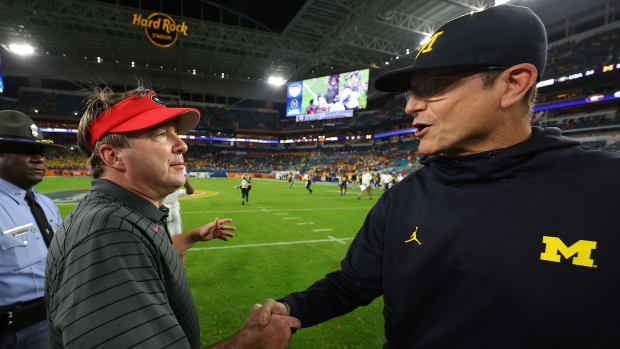 Kirby Smart and Jim Harbaugh shake hands at midfield after a game.