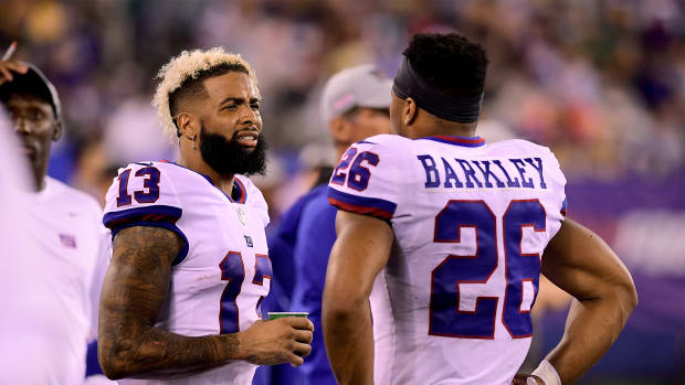 Odell Beckham and Saquon Barkley speak on the sideline while playing for the New York Giants.