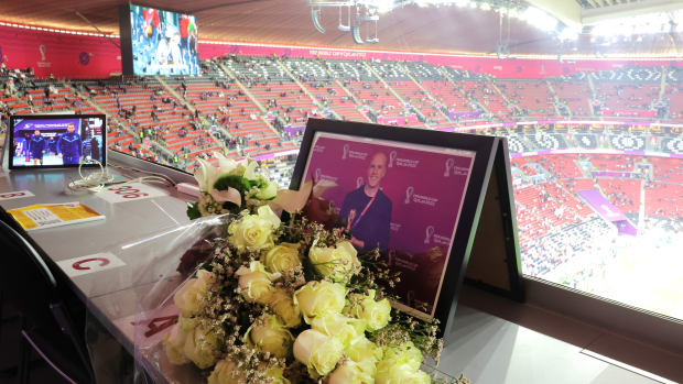 Flowers and a picture in memory of Grant Wahl, an American soccer writer who suddenly died while reporting on the Argentina-Netherlands match.