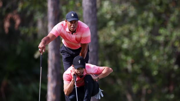 ORLANDO, FLORIDA - DECEMBER 17:  Tiger Woods of the United States and son Charlie Woods line up a putt on the first green during the first round of the PNC Championship at Ritz-Carlton Golf Club on December 17, 2022 in Orlando, Florida. (Photo by Mike Ehrmann/Getty Images)