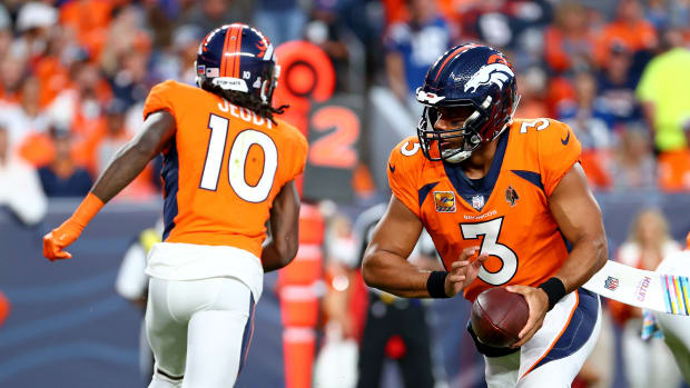 DENVER, COLORADO - OCTOBER 06: Russell Wilson #3 hands off to Jerry Jeudy #10 of the Denver Broncos during a game against the Indianapolis Colts at Empower Field At Mile High on October 06, 2022 in Denver, Colorado. (Photo by Justin Tafoya/Getty Images)