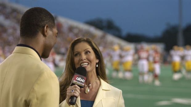 CANTON, OH - AUGUST 4:  ABC's Monday Night Football sideline reporter Lisa Guerrero interviews Pro Football Hall of Fame enshrinee Marcus Allen during the Hall of Fame game between the Green Bay Packers and the Kansas City Chiefs at Fawcett Stadium on August 4, 2003 in Canton, Ohio.  The Chiefs held 9-0 lead when game was called due to unsuitable weather conditions.  (Photo by David Maxwell/Getty Images)