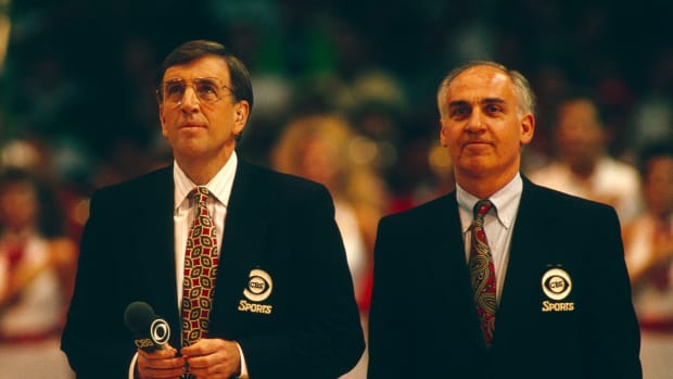 DENVER, CO - MARCH 31: CBS broadcasters Brent Musburger and Billy Packer prepare to call the game between the Arkansas Razorbacks and the Duke Blue Devils during a semifinal game in the 1990 NCAA Men's Final Four held at McNichols Arena on March 31, 1990 in Denver, Colorado. Duke defeated Arkansas  97-83 to advance to the championship game. (Photo by Rich Clarkson/NCAA Photos via Getty Images)