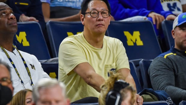 University of Michigan president Santa Ono watches a basketball game between the Wolverines and Ohio Bobcats.