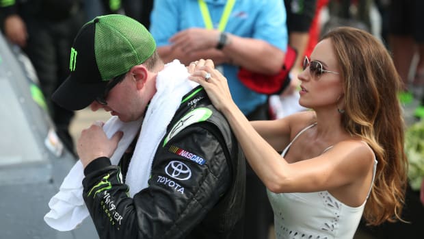 NASCAR driver Kyle Busch assisted by his wife.