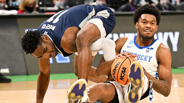 Kentucky's Keion Brooks fights for a loose ball during a game.