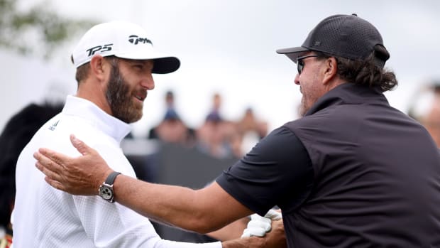 ST ALBANS, ENGLAND - JUNE 09: Dustin Johnson of 4 Aces GC greets Phil Mickelson of Hy Flyers GC during day one of the LIV Golf Invitational - London at The Centurion Club on June 09, 2022 in St Albans, England. (Photo by Charlie Crowhurst/LIV Golf/Getty Images)