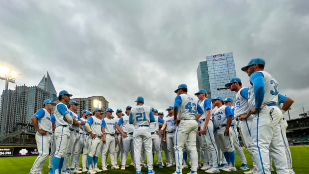 North Carolina baseball players huddle up for a meeting with their manager before a game.