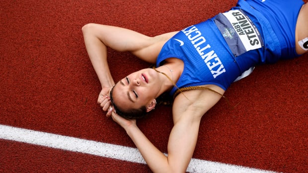 Kentucky runner Abby Steiner lays on the track after winning the 4x400 relay.
