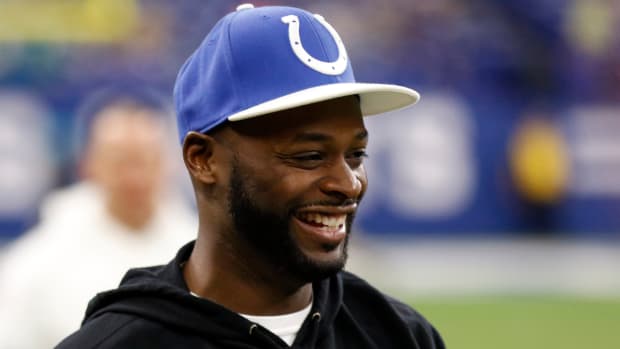 A picture of former Colts star Reggie Wayne in a Colts hat on the sideline.