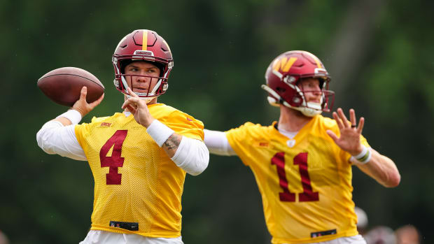 ASHBURN, VA - JUNE 14: Quarterbacks Taylor Heinicke #4 and Carson Wentz #11 of the Washington Commanders participate in a drill during the organized team activity at INOVA Sports Performance Center on June 14, 2022 in Ashburn, Virginia. (Photo by Scott Taetsch/Getty Images)