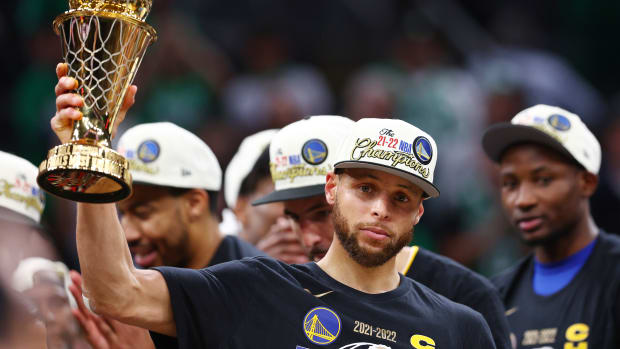 BOSTON, MASSACHUSETTS - JUNE 16: Stephen Curry #30 of the Golden State Warriors celebrates with the Bill Russell NBA Finals Most Valuable Player Award after defeating the Boston Celtics 103-90 in Game Six of the 2022 NBA Finals at TD Garden on June 16, 2022 in Boston, Massachusetts.  (Photo by Elsa/Getty Images)