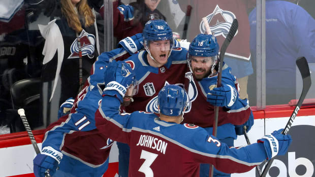 DENVER, COLORADO - JUNE 18: Josh Manson #42 of the Colorado Avalanche celebrates with Andrew Cogliano #11, Jack Johnson #3 and Alex Newhook #18 of the Colorado Avalanche after scoring a goal during the first period in Game Two of the 2022 NHL Stanley Cup Final against the Tampa Bay Lightning at Ball Arena on June 18, 2022 in Denver, Colorado. (Photo by Bruce Bennett/Getty Images)