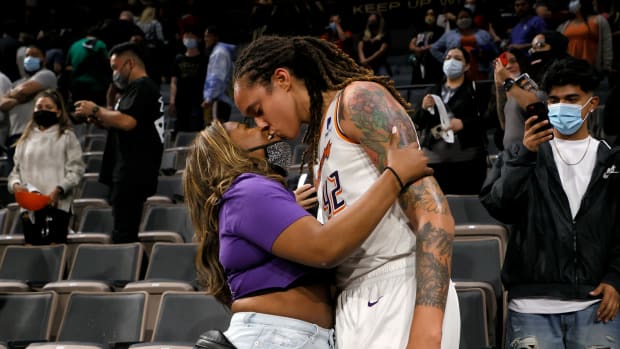 Brittney Griner and her wife, Cherelle, on the floor of a WNBA game earlier this season.