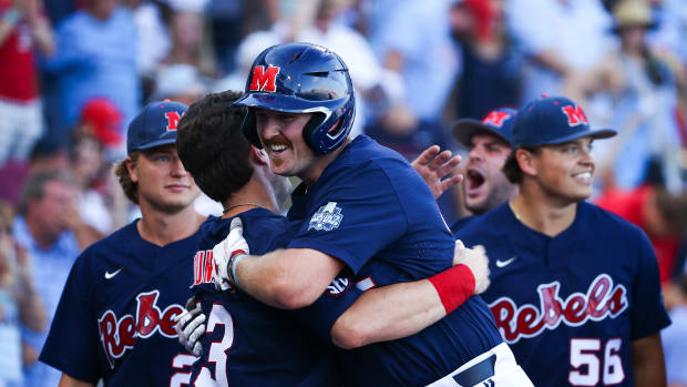 OMAHA, NE - JUNE 25: Tim Elko #25 of the Ole Miss Rebels celebrates with teammates after scoring against the Oklahoma Sooners during the Division I Men's Baseball Championship held at Charles Schwab Field Omaha on June 25, 2022 in Omaha, Nebraska. (Photo by Jamie Schwaberow/NCAA Photos via Getty Images)