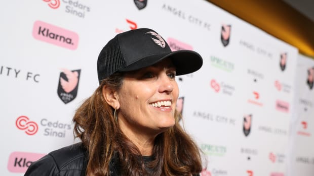 Julie Foudy speaks on the pink carpet before an Angel City FC game.