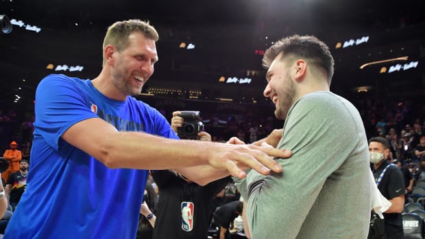PHOENIX, AZ - MAY 15: NBA Legend, Dirk Nowitzki, congratulates Luka Doncic #77 of the Dallas Mavericks after the game against the Phoenix Suns during Game 7 of the 2022 NBA Playoffs Western Conference Semifinals on May 15, 2022 at Footprint Center in Phoenix, Arizona. NOTE TO USER: User expressly acknowledges and agrees that, by downloading and or using this photograph, user is consenting to the terms and conditions of the Getty Images License Agreement. Mandatory Copyright Notice: Copyright 2022 NBAE (Photo by Michael Gonzales/NBAE via Getty Images)