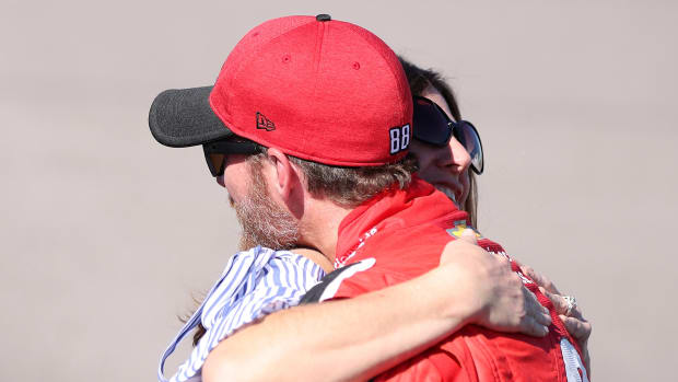 Kelley Earnhardt hugs her brother, Dale Earnhardt Jr., on the track at a NASCAR event.
