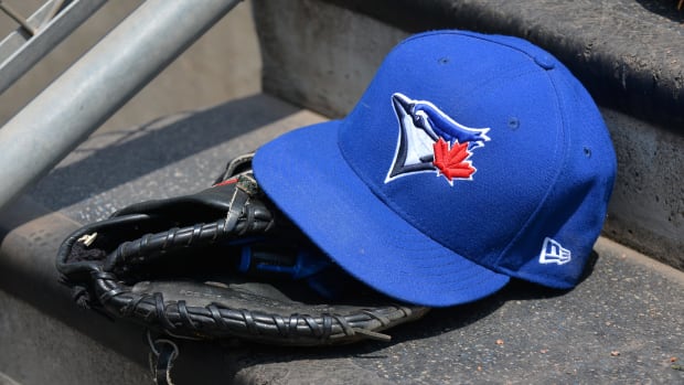 DETROIT, MI - JULY 16:  A detailed view of a Toronto Blue Jays baseball hat and glove sitting on the dugout steps during the game against the Detroit Tigers at Comerica Park on July 16, 2017 in Detroit, Michigan. The Tigers defeated the Blue Jays 6-5.  (Photo by Mark Cunningham/MLB Photos via Getty Images)