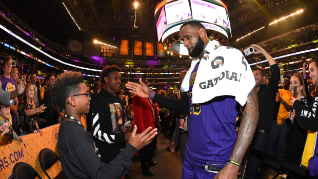 LOS ANGELES, CA - NOVEMBER 23: LeBron James #23 of the Los Angeles Lakers is seen shaking hands with his sons Bryce Maximus James and LeBron James Jr. after winning the game against the Utah Jazz on November 23, 2018 at STAPLES Center in Los Angeles, California. NOTE TO USER: User expressly acknowledges and agrees that, by downloading and/or using this Photograph, user is consenting to the terms and conditions of the Getty Images License Agreement. Mandatory Copyright Notice: Copyright 2018 NBAE (Photo by Andrew D. Bernstein/NBAE via Getty Images)