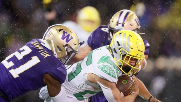 SEATTLE, WASHINGTON - NOVEMBER 06: Travis Dye #26 of the Oregon Ducks carries the ball against the Washington Huskies during the fourth quarter at Husky Stadium on November 06, 2021 in Seattle, Washington. (Photo by Steph Chambers/Getty Images)