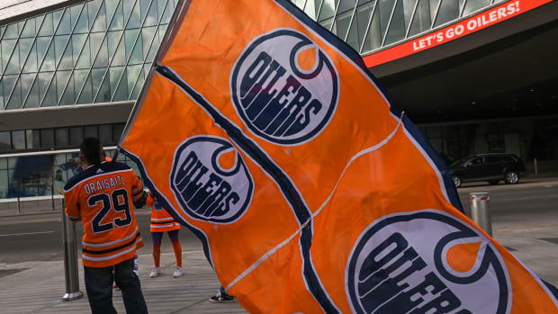 A fan waving the Oilers flag in front of Rogers Place Arena.
Hundreds of Edmonton Oilers fans gathered in the Ice District Plaza on Monday evening to celebrate the Oilers' first game in the 2022 Stanley Cup playoffs.
On Monday, May 2, 2022, in Edmonton, Alberta, Canada. (Photo by Artur Widak/NurPhoto via Getty Images)