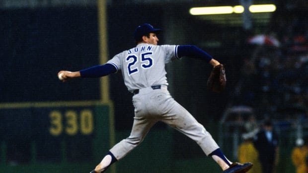 PHILADELPHIA, PA - CIRCA 1974: Pitcher Tommy John #25 of the Los Angeles Dodgers pitches against the Philadelphia Phillies during an Major League Baseball game circa 1974 at Veterans Stadium in Philadelphia, Pennsylvania. John  played for the Dodgers from 1972-74 and 1976-78. (Photo by Focus on Sport/Getty Images) 