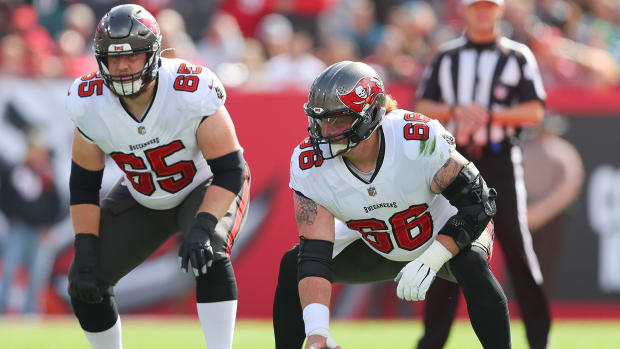 TAMPA, FLORIDA - JANUARY 16: Alex Cappa #65 and Ryan Jensen #66 of the Tampa Bay Buccaneers in action against the Philadelphia Eagles in the first half of the NFC Wild Card Playoff game at Raymond James Stadium on January 16, 2022 in Tampa, Florida.  (Photo by Michael Reaves/Getty Images)