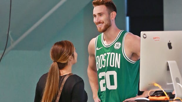 BOSTON, MA - SEPTEMBER 13: Boston Celtics' Gordon Hayward smiles in uniform with his wife Robyn, left, during a photo shoot after meeting with the media at the team's practice facility in the Brighton neighborhood of Boston to give an update on his condition as he comes back from the left ankle/foot injury he suffered during last season's opening game in Cleveland on Sep. 13, 2018. (Photo by Jim Davis/The Boston Globe via Getty Images)