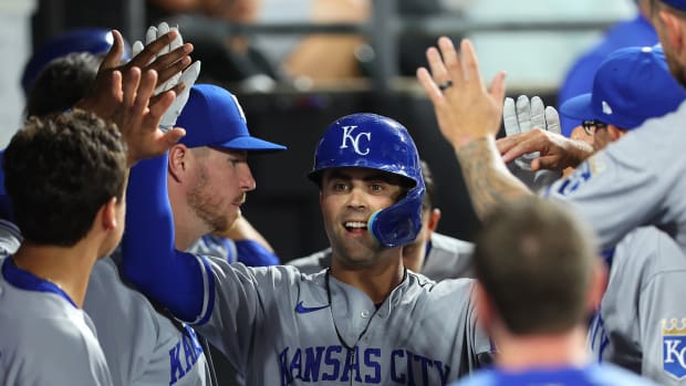 CHICAGO, ILLINOIS - AUGUST 01: Whit Merrifield #15 of the Kansas City Royals high fives teammates after hitting a solo home run during the sixth inning against the Chicago White Sox at Guaranteed Rate Field on August 01, 2022 in Chicago, Illinois. (Photo by Michael Reaves/Getty Images)