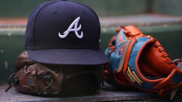 PHILADELPHIA, PA - JULY 26: A general view of gloves and an Atlanta Braves hat against the Philadelphia Phillies at Citizens Bank Park on July 26, 2022 in Philadelphia, Pennsylvania. The Braves defeated the Phillies 6-3. (Photo by Mitchell Leff/Getty Images)