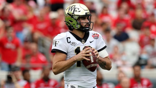 JACKSONVILLE, FLORIDA - DECEMBER 31: Sam Hartman #10 of the Wake Forest Demon Deacons looks to pass against the Rutgers Scarlet Knights during the TaxSlayer Gator Bowl at TIAA Bank Field on December 31, 2021 in Jacksonville, Florida. (Photo by Sam Greenwood/Getty Images)