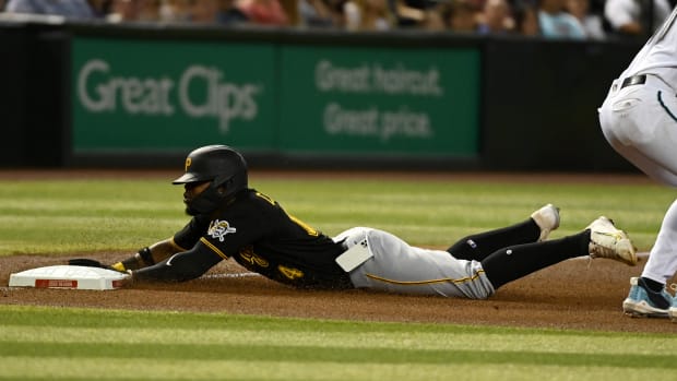 PHOENIX, ARIZONA - AUGUST 09: Rodolfo Castro #14 of the Pittsburgh Pirates slides into third base as his cell phone falls out of his pocket during the fourth inning of a game against the Arizona Diamondbacks at Chase Field on August 09, 2022 in Phoenix, Arizona. (Photo by Norm Hall/Getty Images)
