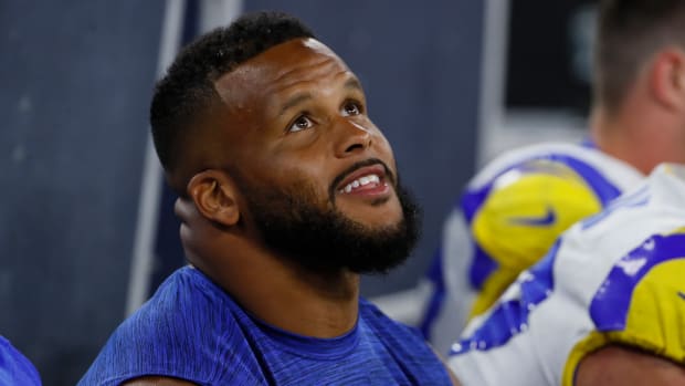 Rams star Aaron Donald sits on the bench during a preseason game.