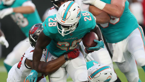 Sony Michel runs the ball for the Miami Dolphins.