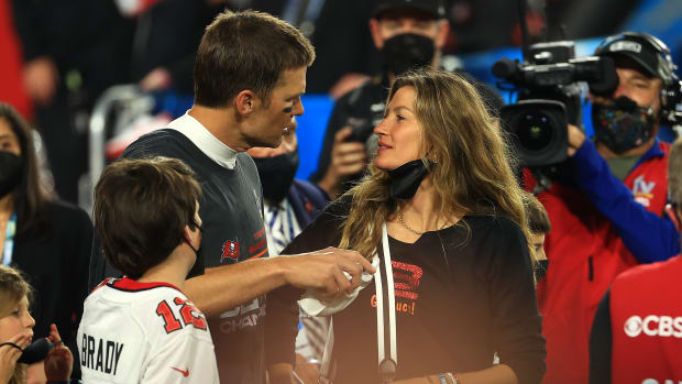 Gisele Bundchen looks at her husband, Tom Brady, on the field after the Super Bowl.