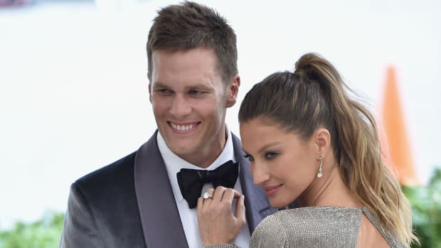 Tom Brady and his wife, Gisele, on the red carpet for an event.